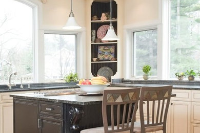 Eat-in kitchen - mid-sized transitional l-shaped medium tone wood floor eat-in kitchen idea in Cleveland with an undermount sink, raised-panel cabinets, white cabinets, granite countertops and an island