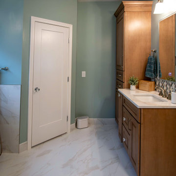 Primary Bath with Marble Look Tiled Shower and Free Standing Tub