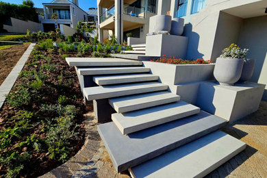 Example of a small trendy concrete floating staircase design in Other with concrete risers