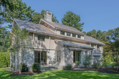Inspiration for a cottage beige two-story wood house exterior remodel in New York with a shingle roof