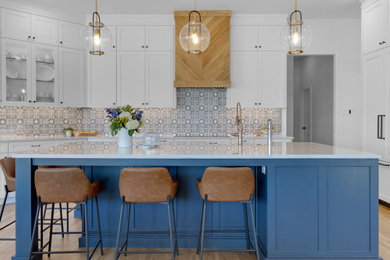 Inspiration for a light wood floor eat-in kitchen remodel in Dallas with an undermount sink, shaker cabinets, terra-cotta backsplash and an island