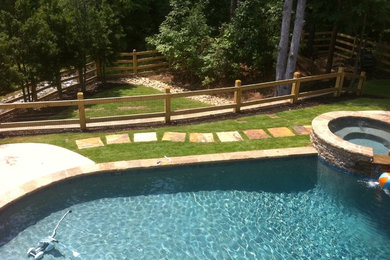 Inspiration for a large traditional backyard custom-shaped aboveground pool in Atlanta with a hot tub.