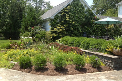 Photo of a large contemporary full sun backyard stone landscaping in Philadelphia.