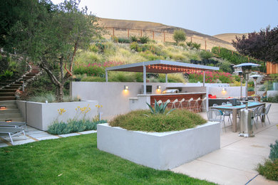 Inspiration for a contemporary patio in San Francisco with an outdoor kitchen and a pergola.