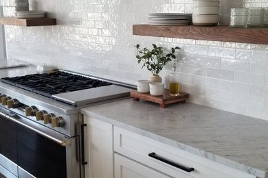 Large trendy single-wall light wood floor, brown floor and shiplap ceiling eat-in kitchen photo in Phoenix with a farmhouse sink, shaker cabinets, white cabinets, quartz countertops, white backsplash, porcelain backsplash, stainless steel appliances, an island and yellow countertops