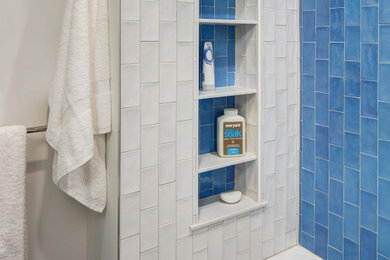 Bathroom - mid-sized transitional blue tile and ceramic tile porcelain tile, gray floor and single-sink bathroom idea in New York with flat-panel cabinets, white cabinets, a two-piece toilet, white walls, an undermount sink, quartz countertops, white countertops, a niche and a built-in vanity