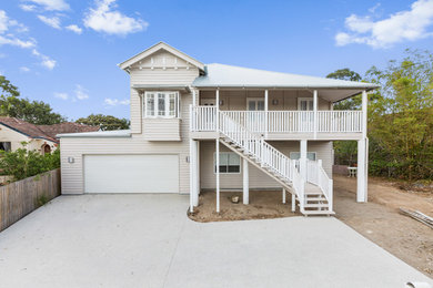 Mid-sized beach style two-storey beige exterior in Brisbane with wood siding and a gable roof.