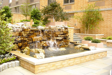 Inspiration for a modern partial sun courtyard water fountain landscape in New York.