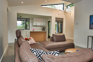 Minimalist gray floor living room photo in Vancouver with beige walls
