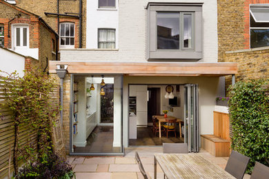 Medium sized traditional back patio in London with no cover.