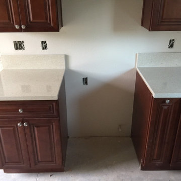 Antique Cherry glaze kitchen & bathroom cabinets and sparking Quartz countertops