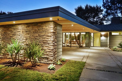 Inspiration for a large mid-century modern green one-story wood house exterior remodel in San Francisco with a hip roof and a shingle roof