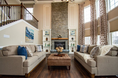 Inspiration for a large timeless open concept dark wood floor family room remodel with beige walls and a stone fireplace