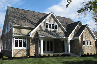 Inspiration for a timeless beige two-story stone exterior home remodel in Columbus