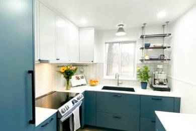 Kitchen - kitchen idea in Vancouver with white backsplash and white countertops