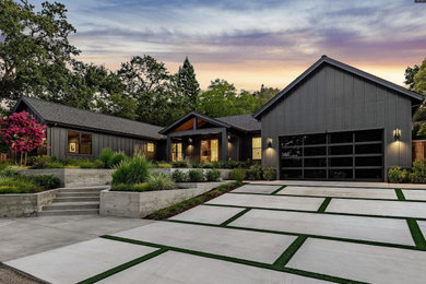 Large minimalist black one-story mixed siding and board and batten exterior home photo in Sacramento with a shingle roof and a black roof