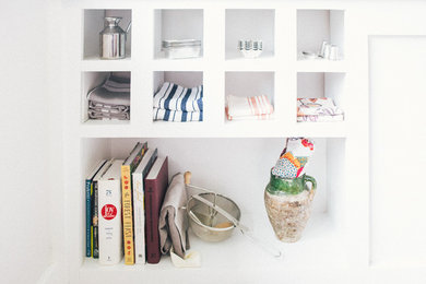 Inspiration for a mid-sized timeless kitchen remodel in Austin with white cabinets and white backsplash
