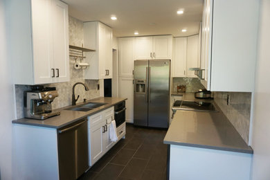 Inspiration for a mid-sized contemporary ceramic tile and black floor eat-in kitchen remodel in Ottawa with an undermount sink, shaker cabinets, white cabinets, quartzite countertops, gray backsplash, marble backsplash, stainless steel appliances, no island and gray countertops