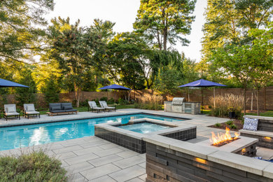 Example of a minimalist backyard concrete paver and rectangular pool landscaping design in DC Metro