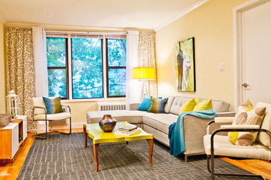 Inspiration for a mid-sized modern medium tone wood floor living room remodel in New York with beige walls