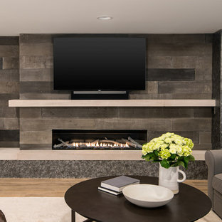 Photo of a medium sized rural look-out basement in Detroit with beige walls, vinyl flooring, a ribbon fireplace, a concrete fireplace surround and brown floors.