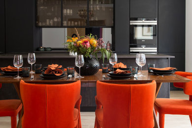 Inspiration for a large contemporary dining room in Kent with white walls, light hardwood flooring and beige floors.