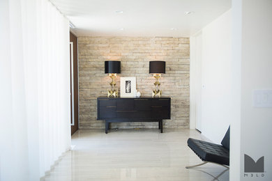 Example of a large trendy ceramic tile and beige floor entryway design in Salt Lake City with white walls and a dark wood front door