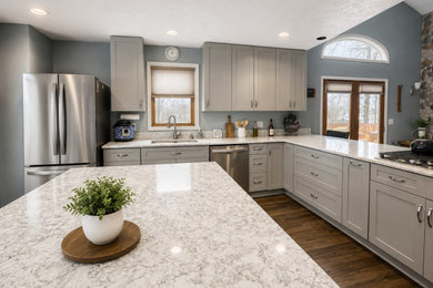 Large minimalist u-shaped dark wood floor and brown floor eat-in kitchen photo in Other with an undermount sink, shaker cabinets, gray cabinets, quartz countertops, stainless steel appliances, two islands and brown countertops