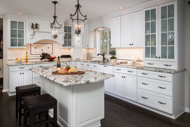 Kitchen - mid-sized traditional l-shaped dark wood floor kitchen idea with an undermount sink, white cabinets, granite countertops, white backsplash, an island and subway tile backsplash