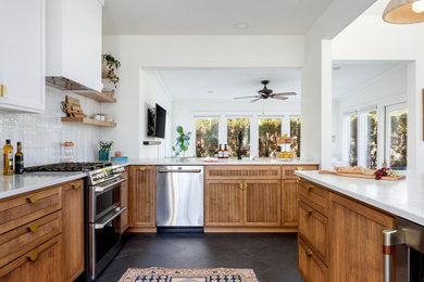 Kitchen - mid-sized mid-century modern l-shaped porcelain tile and black floor kitchen idea in Columbus with an undermount sink, beaded inset cabinets, light wood cabinets, quartz countertops, white backsplash, ceramic backsplash, stainless steel appliances, an island and white countertops