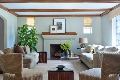 Example of a mid-sized transitional enclosed medium tone wood floor living room design in Boston with green walls, a standard fireplace, a brick fireplace and no tv