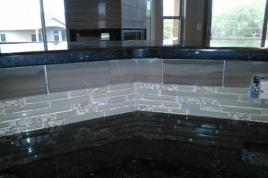 Minimalist kitchen photo in Denver with granite countertops, gray backsplash and marble backsplash