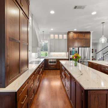 Galley kitchen view with two-tone cabinetry and marble subway backsplash