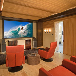 Example of a zen enclosed light wood floor home theater design in Denver with beige walls and a projector screen
