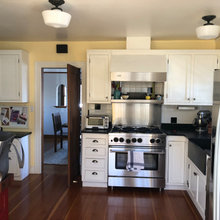 Kitchen with white cabinets and wood trim