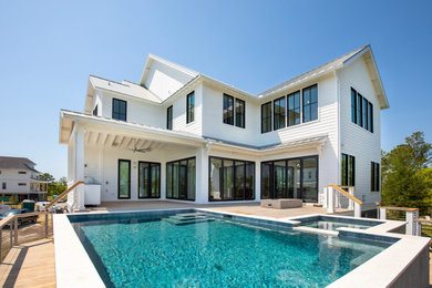 Example of a large minimalist backyard rectangular aboveground pool design in Charleston with decking