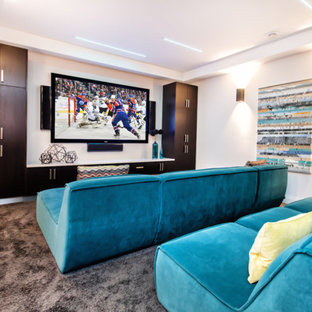 Inspiration for a contemporary carpeted home theater remodel in Edmonton with white walls and a wall-mounted tv