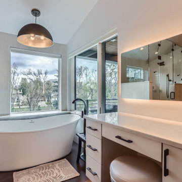 Modern Spa-Inspired Primary Bathroom with Custom Lighting and Views