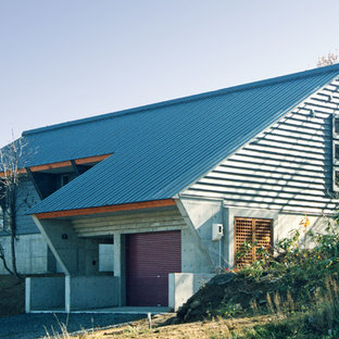 他の地域のコンテンポラリースタイルのおしゃれな家の外観 (コンクリートサイディング、グレーの外壁、片流れ屋根) の写真