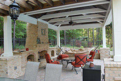 Mid-sized elegant backyard stone patio photo in Raleigh with a pergola