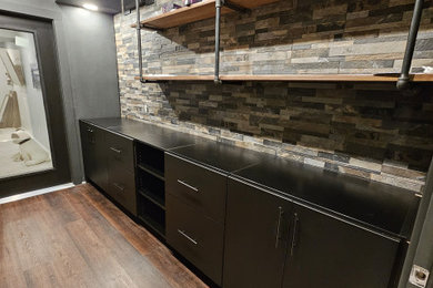 Inspiration for a mid-sized modern wine cellar in Cleveland with vinyl floors and brown floor.
