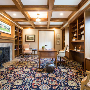 Foto de despacho tradicional renovado, grande, con paredes beige, moqueta, chimenea tradicional, marco de chimenea de piedra, escritorio independiente y suelo azul