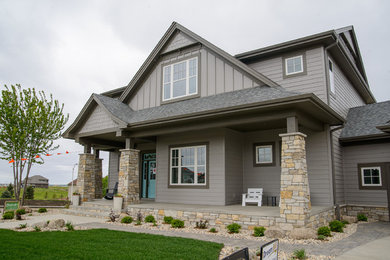 Large arts and crafts gray two-story wood exterior home photo in Other with a shingle roof
