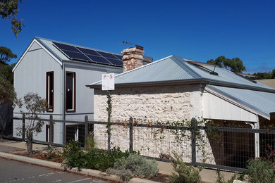 Mid-sized beach style grey house exterior in Perth with mixed siding, a gable roof and a metal roof.