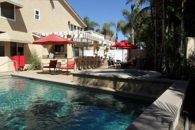 Hot tub - large traditional backyard stone and rectangular lap hot tub idea in Los Angeles