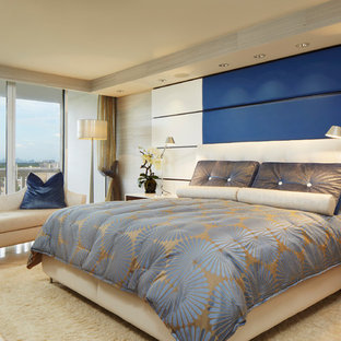 Design ideas for a mid-sized contemporary master bedroom in Miami with blue walls and marble floors.