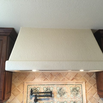 Old world plaster on Kitchen hood with hand painted art work