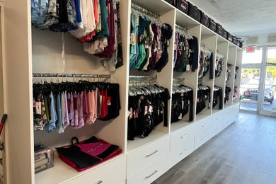 This is an example of a large contemporary wardrobe in Miami.