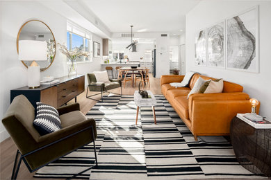 Living room - contemporary open concept light wood floor and beige floor living room idea in Los Angeles with white walls
