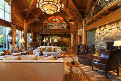Photo of a large country formal open concept living room in Other with brown walls, light hardwood floors, a standard fireplace, a stone fireplace surround and no tv.